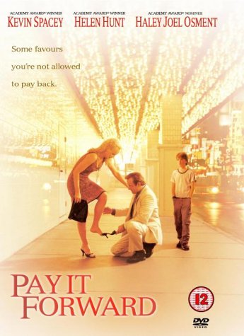 Pay It Forward" DVD cover: man helping woman, boy watching, bright lights.
