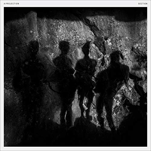 Black and white album cover showing four dark human shadows cast against a rock wall.