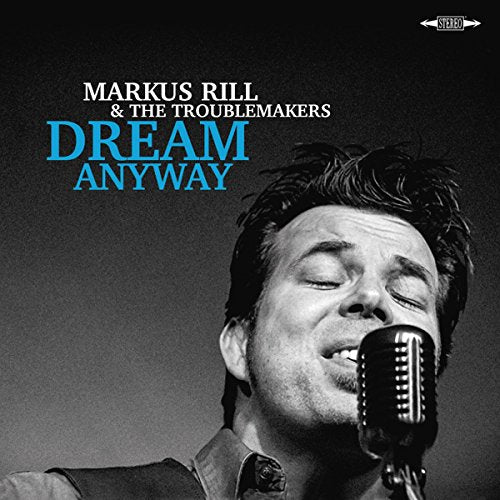 Album cover with man singing into microphone, eyes closed, against a dark background.