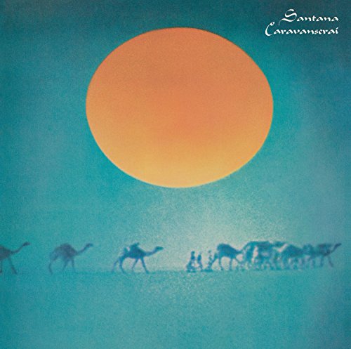 Album cover: camels silhouetted against a large orange sun in a blue sky.