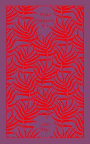 "Book cover with red leaf pattern on purple background, titled 'Wide Sargasso Sea' by Jean Rhys."