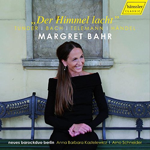 "Woman in black dress sits on ornate bench, smiling, on a CD cover."