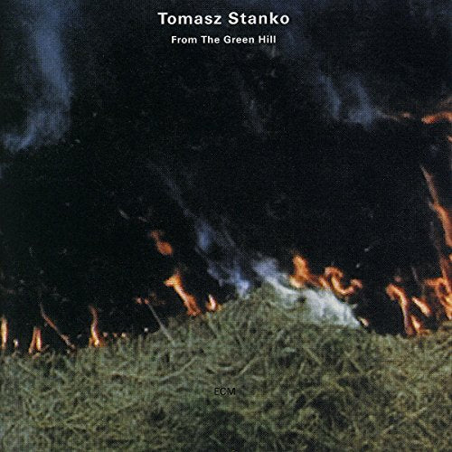 "Tomasz Stanko album cover showing a grassy hill with fire at the base."