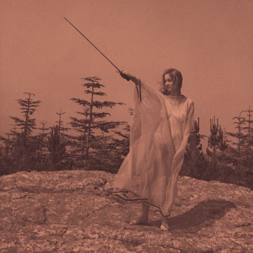 Person in white robe holds a long, dark object outdoors.