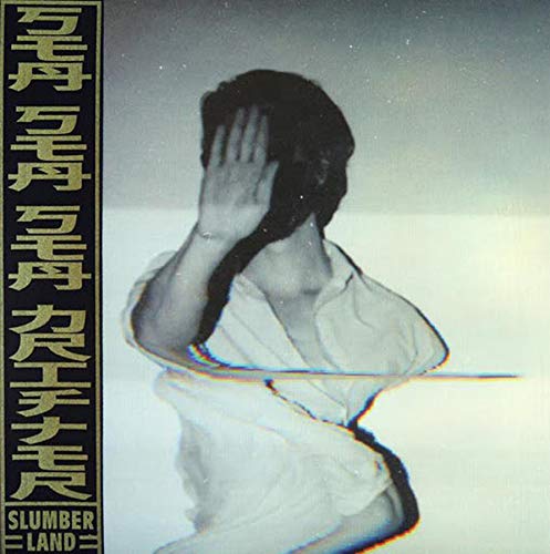The image depicts a black-and-white photograph of a person in a white shirt, obscuring their face. For accessibility purposes, a concise alt text could be: "Black-and-white image of person in white shirt covering their face."