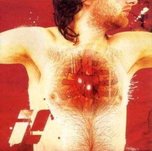 "Album cover with a shirtless man and a mechanical heart on a red background."