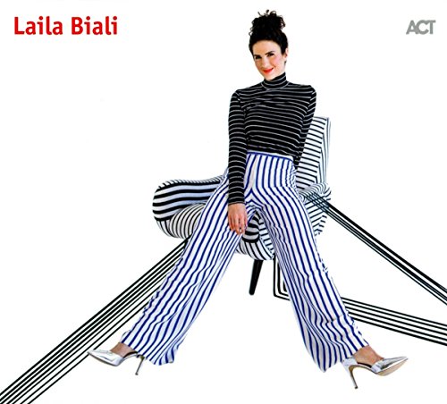 Woman in striped outfit sits on a chair with abstract black lines around her.