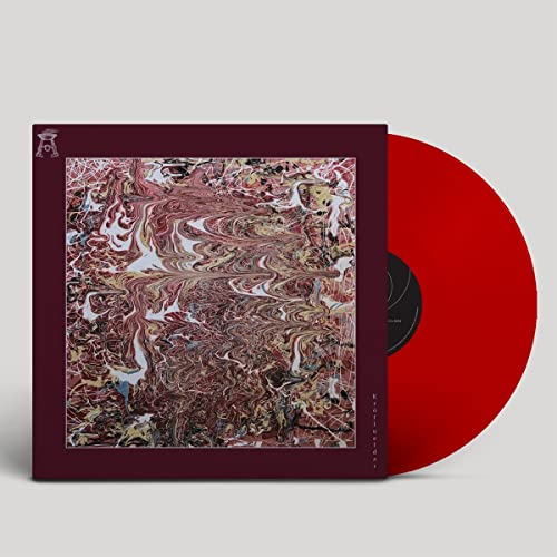 Vinyl record with marbled red and cream cover, bright red disc visible.