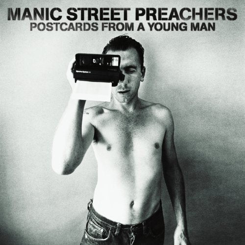 Black and white album cover with shirtless man holding a camera to his face.