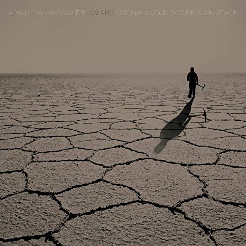 Vinyl record cover: cracked earth, lone figure with a tool, sepia tone.