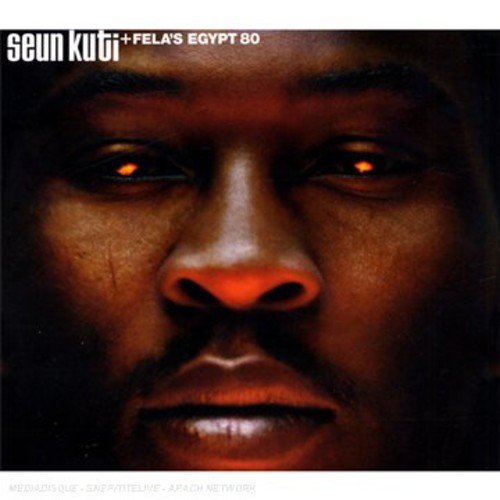 "Album cover featuring a close-up of a man's face with glowing eyes."