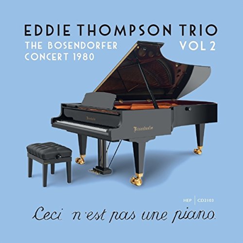 "CD cover featuring a grand piano on a blue background with text."