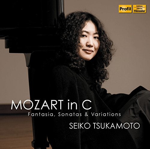 "CD cover with a woman sitting beside a piano, wearing a black outfit."