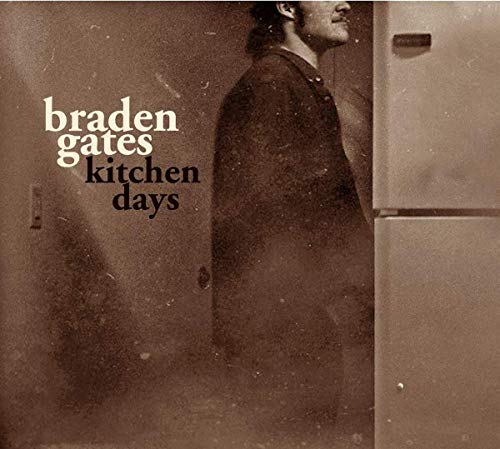 "CD cover with sepia-toned image of man standing beside a refrigerator."