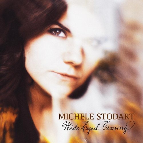 A woman's portrait on a CD cover with the title "Wide Eyed Crossing" by Michele Stodart.