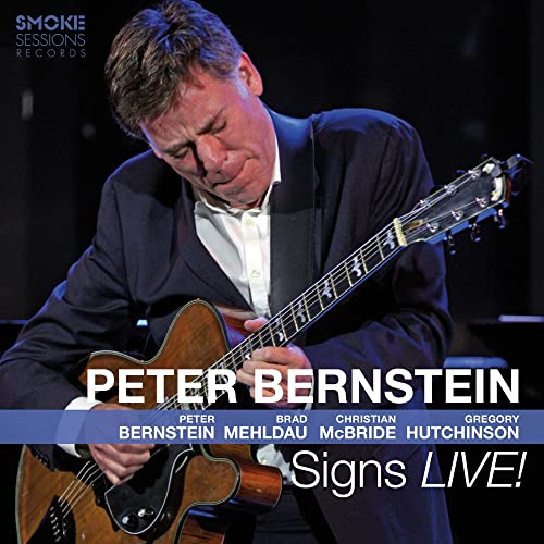 Peter Bernstein playing a hollow-body electric guitar on the Signs LIVE! CD cover.
