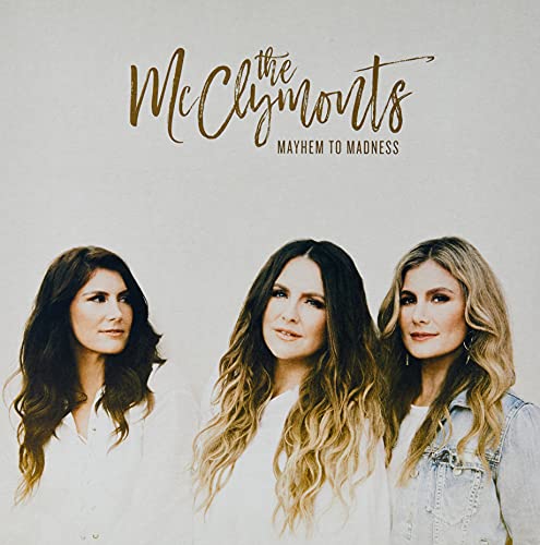 Album cover for The McClymonts’ “Mayhem To Madness” featuring three women.