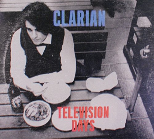 "Album cover with a man sitting at a table, surrounded by broken plates."
