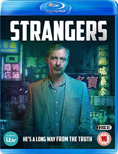 "Blu-ray case with man in a suit against neon-lit city background."