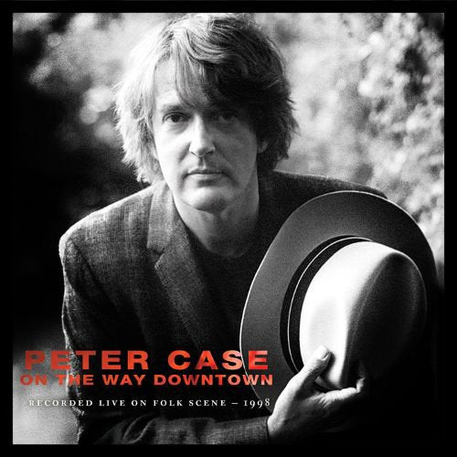 Album cover featuring a black-and-white photo of a man holding a hat.