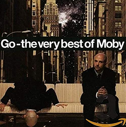 Album cover featuring Moby sitting on a bench in a city street at night.