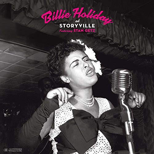 Billie Holiday singing into a vintage microphone, black and white portrait.