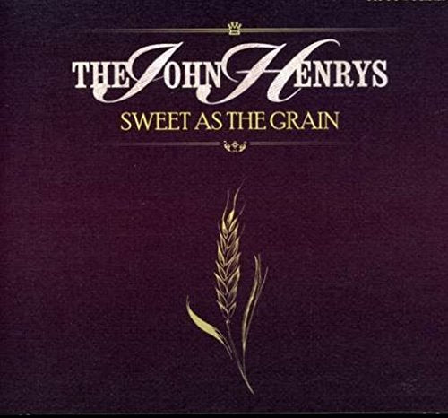"Album cover with dark purple background, gold wheat stalk, and white and gold text."