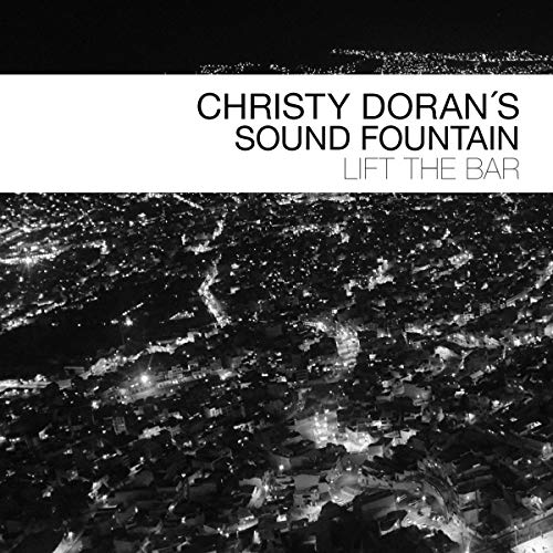 "Album cover with aerial view of city at night, white text on black background."