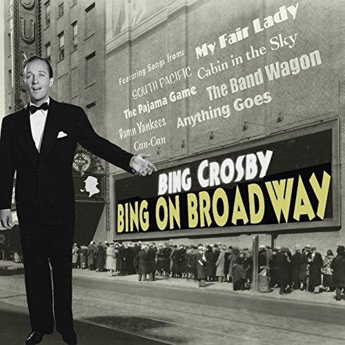 Bing Crosby in a tuxedo stands beside a Broadway theater marquee.