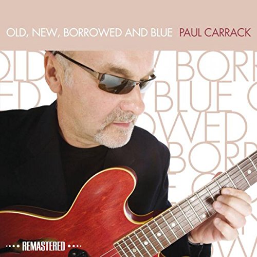 "Album cover featuring Paul Carrack playing a red guitar, wearing sunglasses and a black shirt."