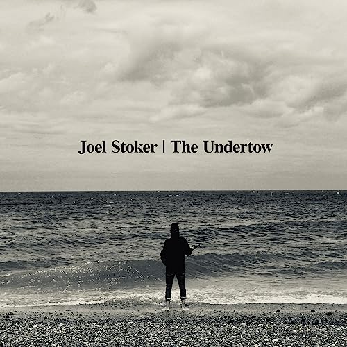 CD cover: seascape with a lone figure playing guitar on a beach.