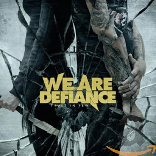 CD cover: Man with tattoos viewed through cracked glass, text “We Are Defiance”.