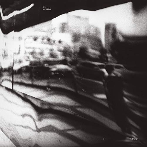 Black and white album cover, blurred city scene, text “in transit”.