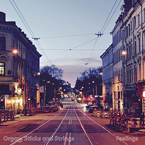CD cover with a street scene at dusk, buildings lining both sides.