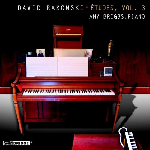 "CD cover featuring a brown piano with sheet music and a microphone."
