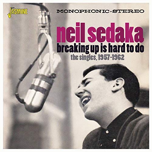 CD cover featuring Neil Sedaka singing into a microphone, black and white with pink text.