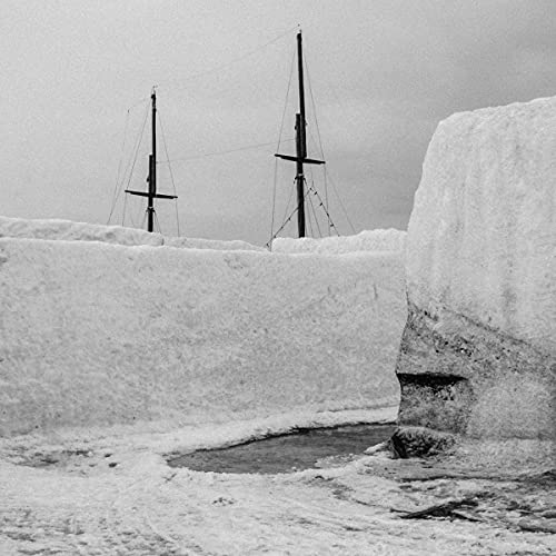 Black and white image of a ship’s masts amidst snow and ice.