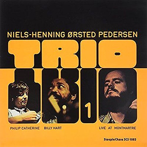 "Vinyl album cover with black and orange design, featuring three men's portraits."