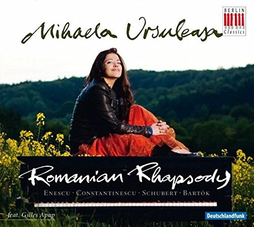 "CD cover with a woman sitting in a field of yellow flowers."
