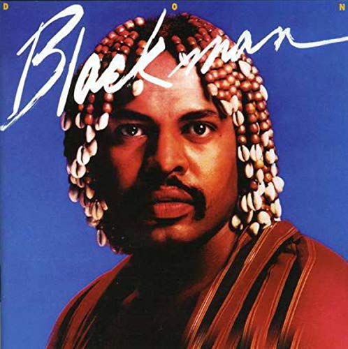 "Album cover featuring a man with braided hair and a blue background, titled 'Blackman'."