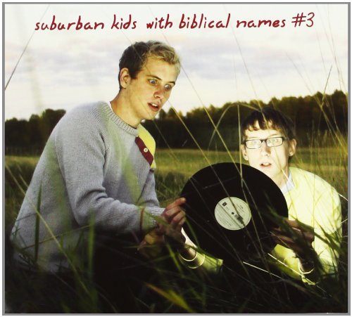 CD cover featuring two young men with a vinyl record in a field.