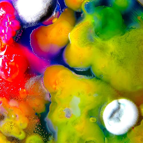 Abstract colorful paint swirls with a silver circular element.