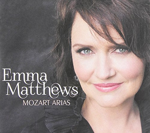 CD cover featuring a woman with dark hair and green eyes against a dark background.