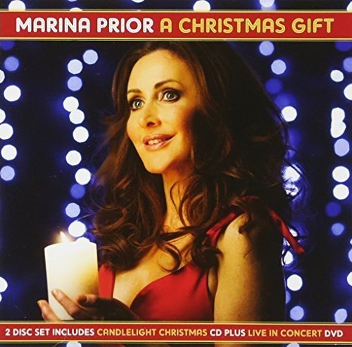 "Album cover featuring a woman in red holding a lit candle, surrounded by lights."
