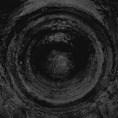Black and white spiral image, resembling a celestial vortex or eye.