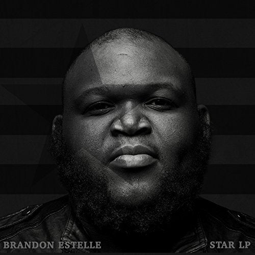 Black and white album cover featuring a man with a shaved head and beard.