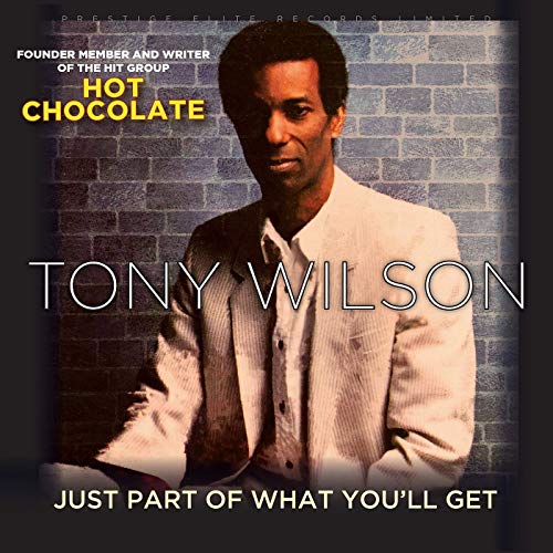 "Tony Wilson album cover with a man in a white jacket against a brick wall."