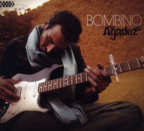 Bombino album cover: man playing white guitar outdoors, desert background, artist name displayed.