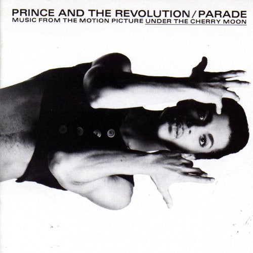 Prince's black and white album cover featuring a man posing with hands up.