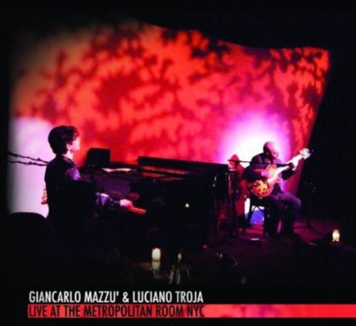 A CD cover featuring two musicians performing on stage with red lighting.